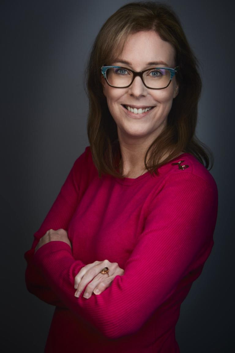 A headshot of a women in business attire.