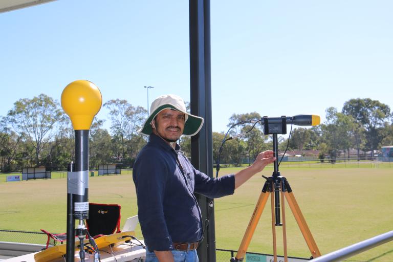 A photograph of a scientist using measuring equipment to monitor 5G radio waves. 