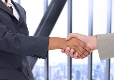 Two office workers shaking hands