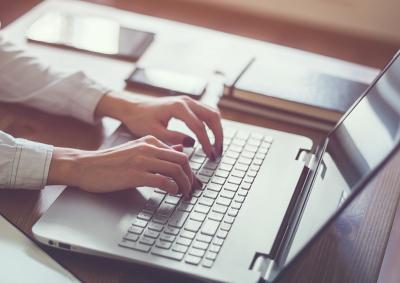 : Photo of person working on a laptop.