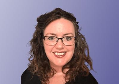 Shannan Quain smiling against a purple background