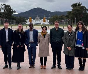 7 graduates from the APSC graduate intake stand outside Parliament House